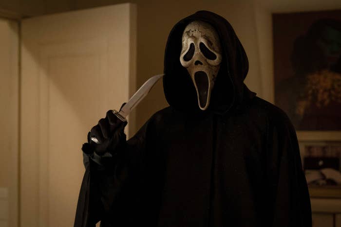 Ghostface holds a knife in an apartment