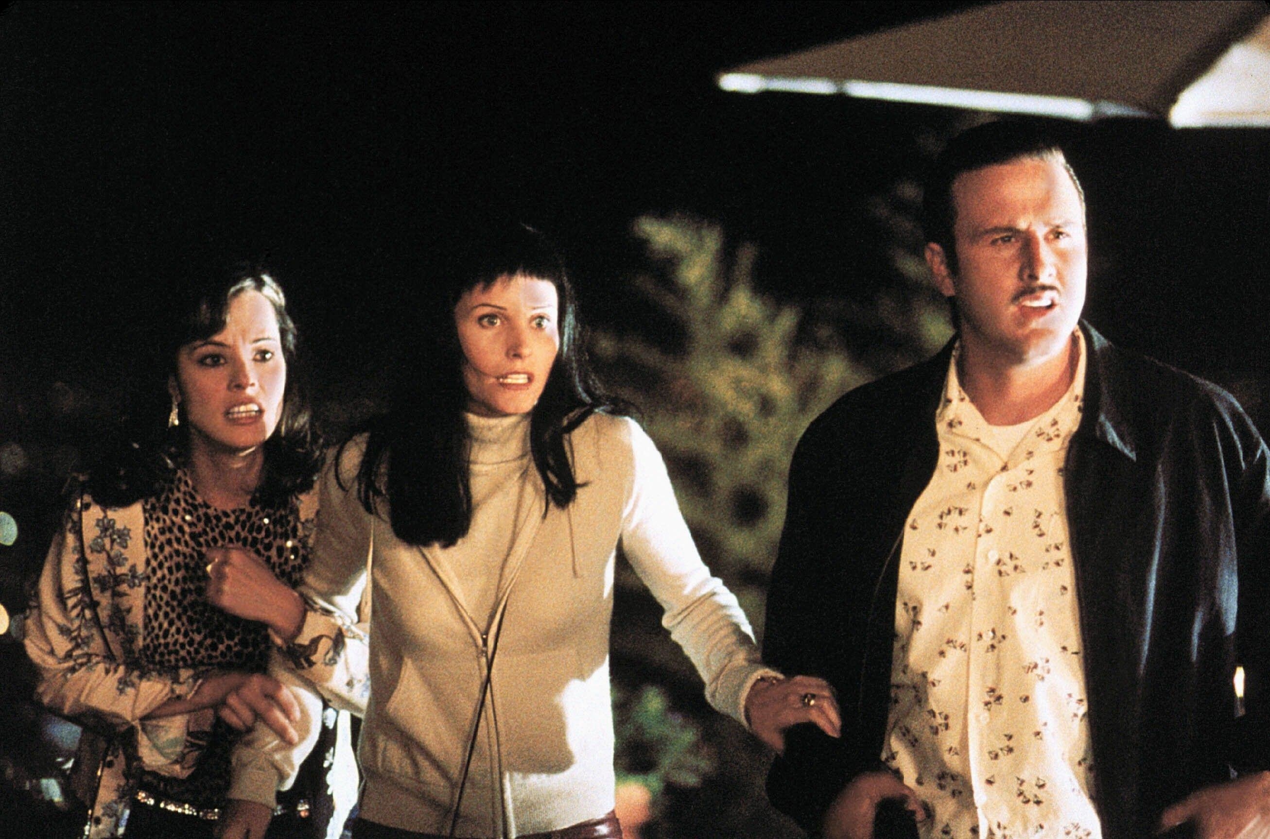 Parker Posey, Courteney Cox and David Arquette are illuminated in the night