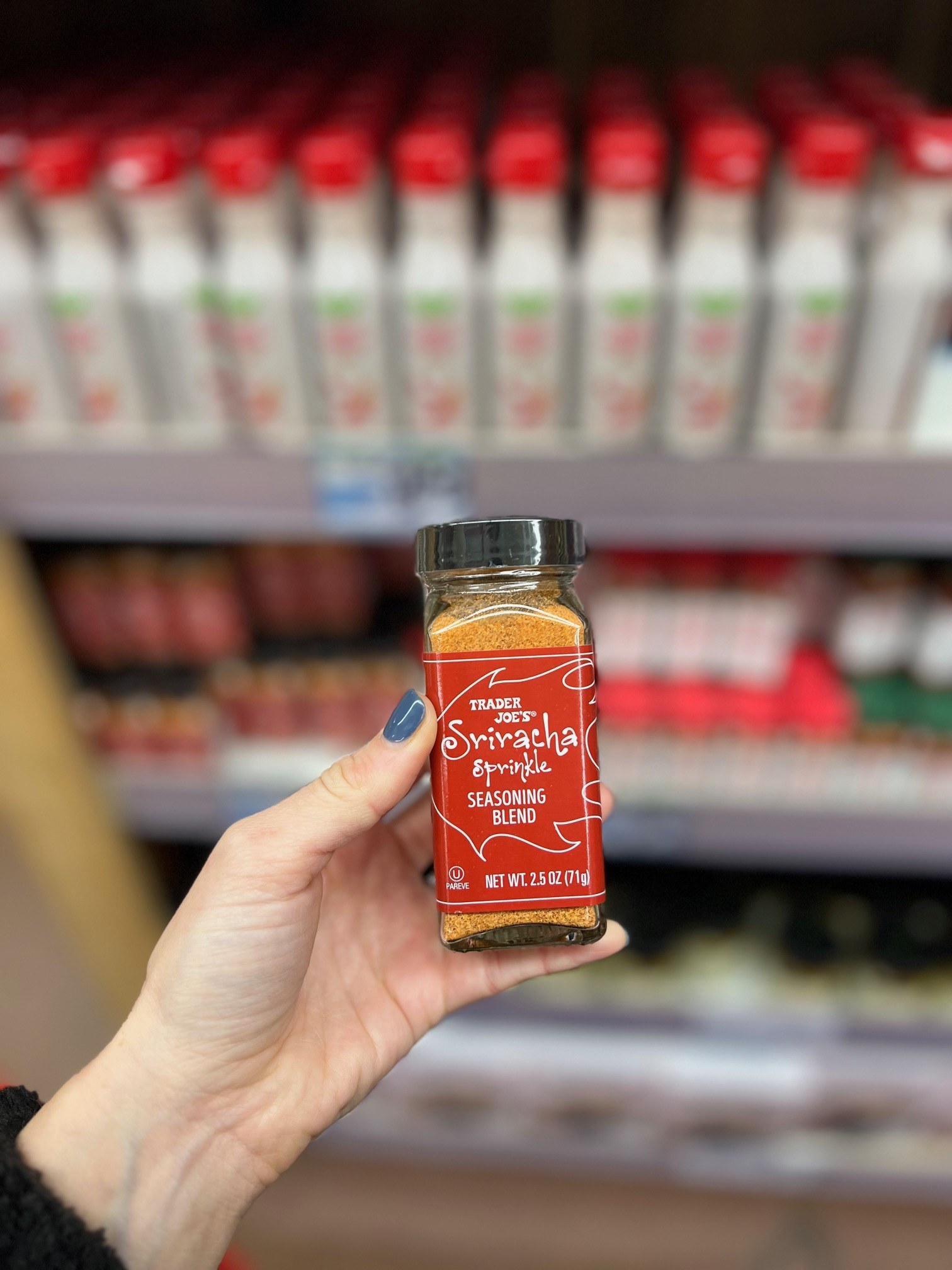 A small jar of Sriracha Sprinkle Seasoning Blend