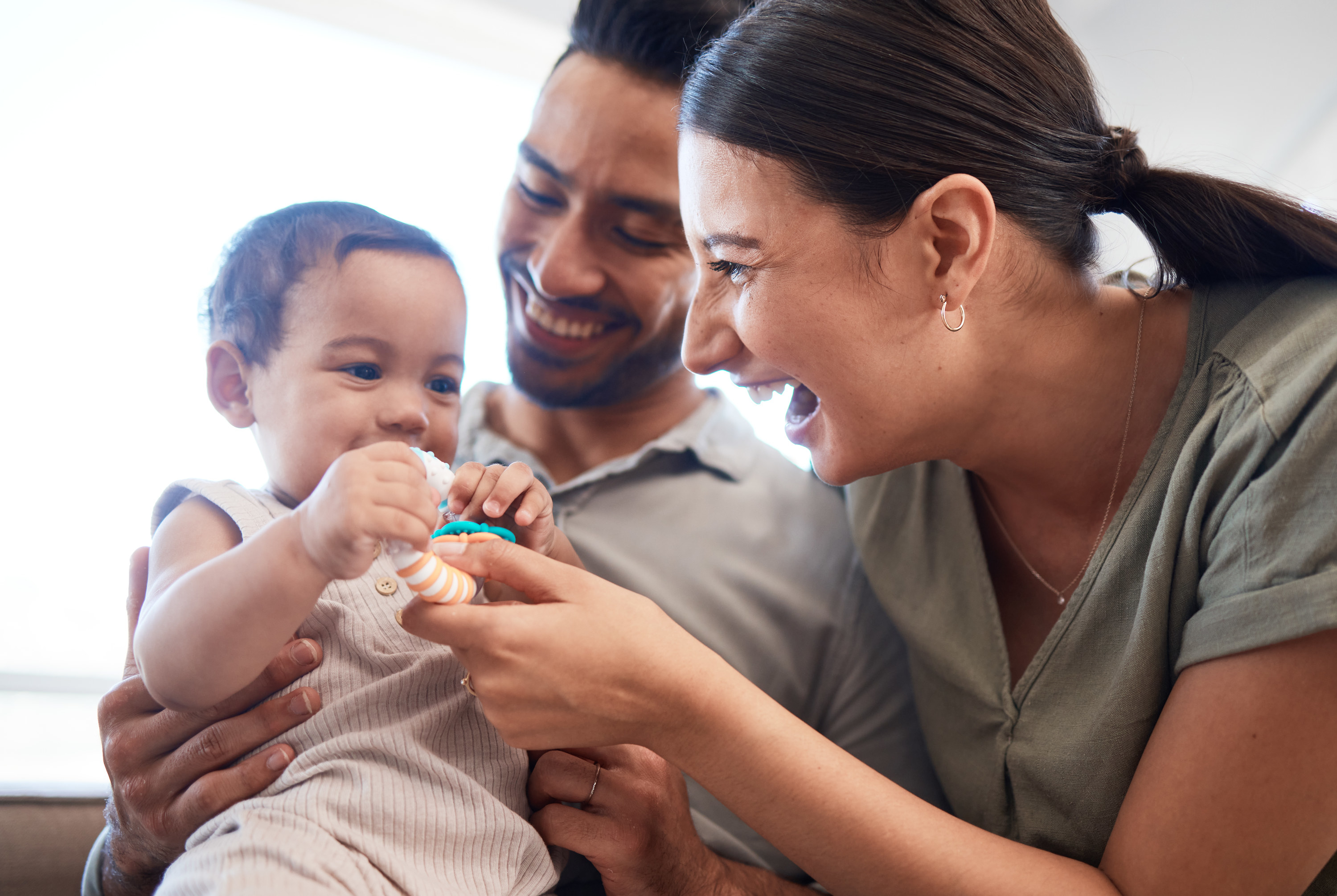 parents smiling with a baby