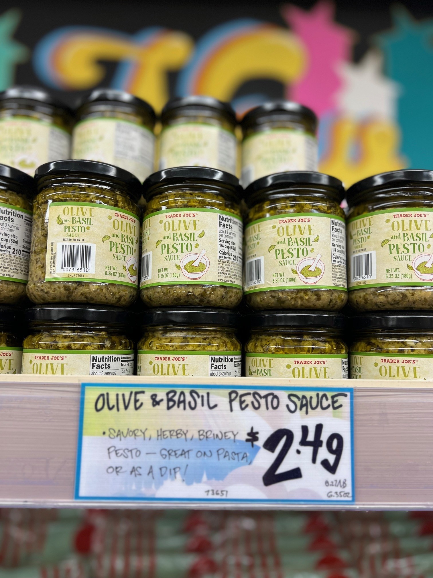 Many small jars of Olive and Basil Pesto Sauce on display