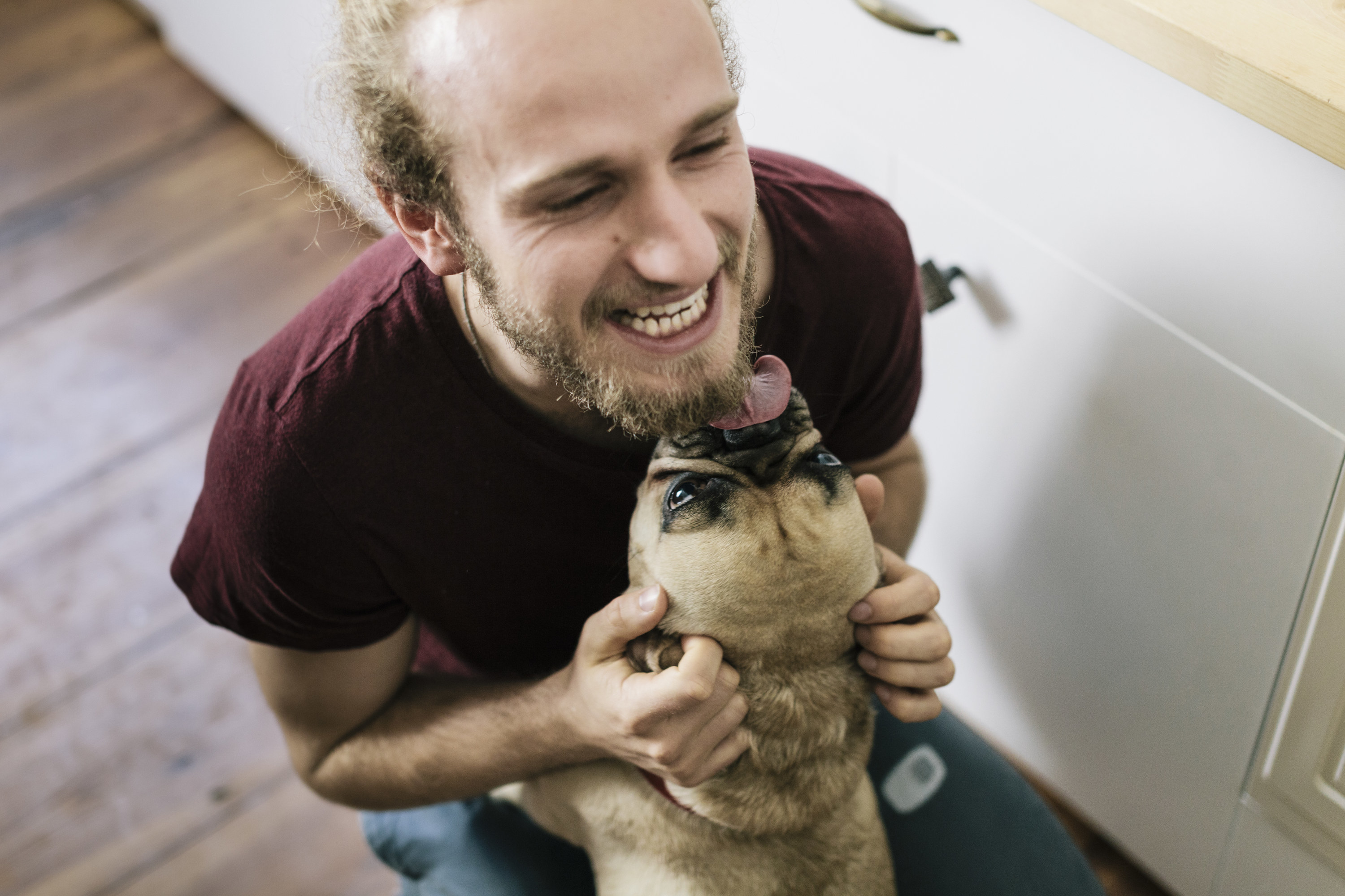 a man hugging a dog