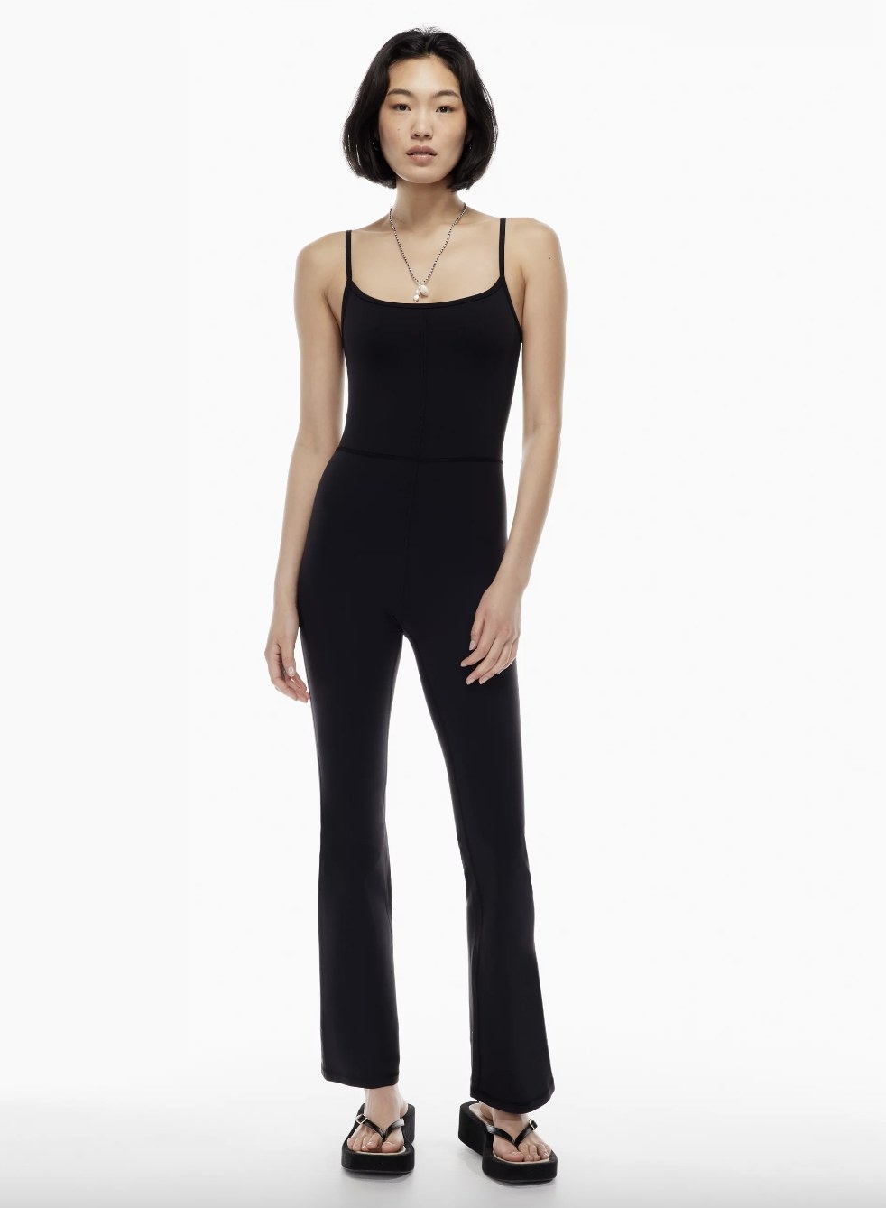 model wearing black sleeveless jumpsuit