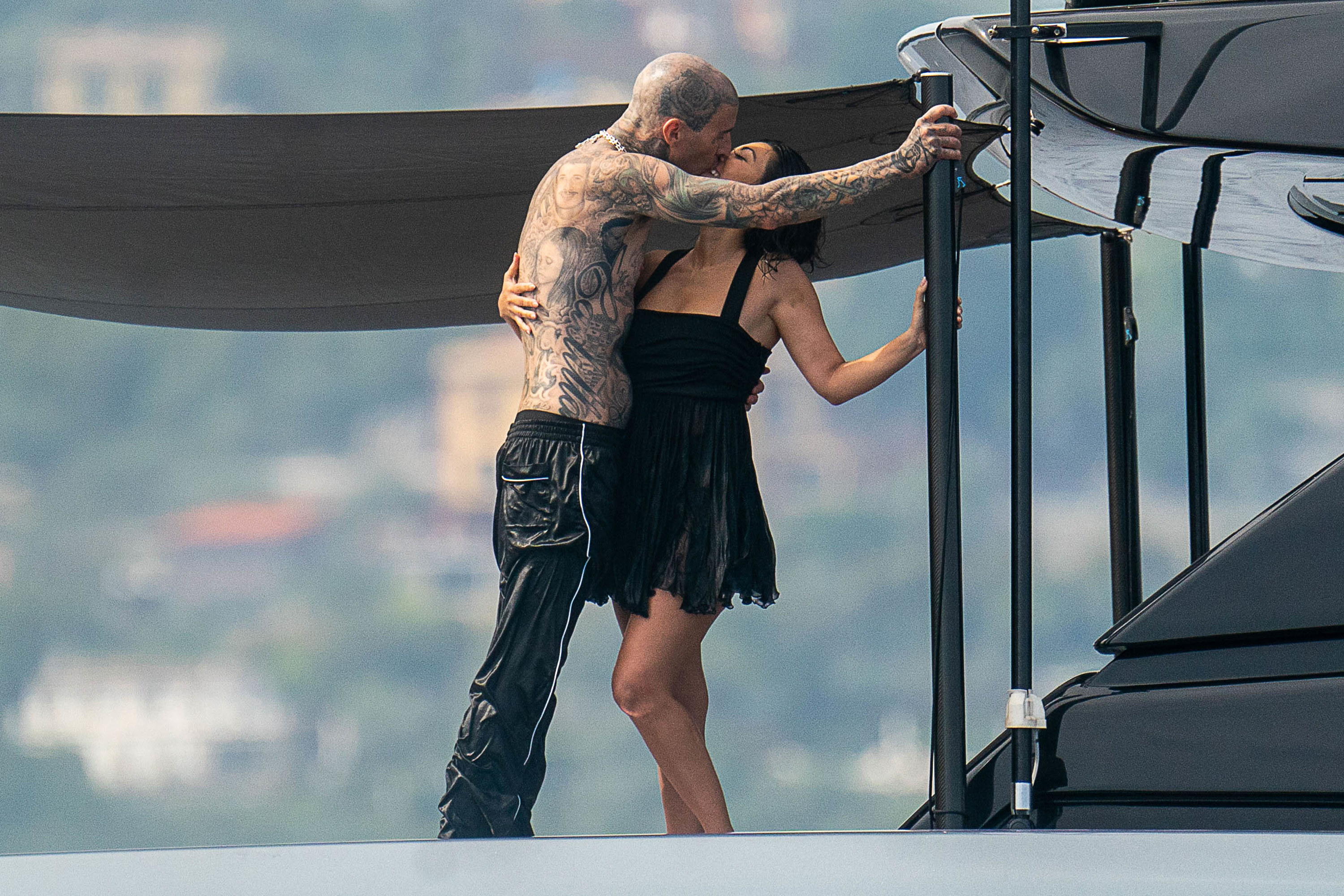 Kourtney and Travis kiss on a boat in Italy