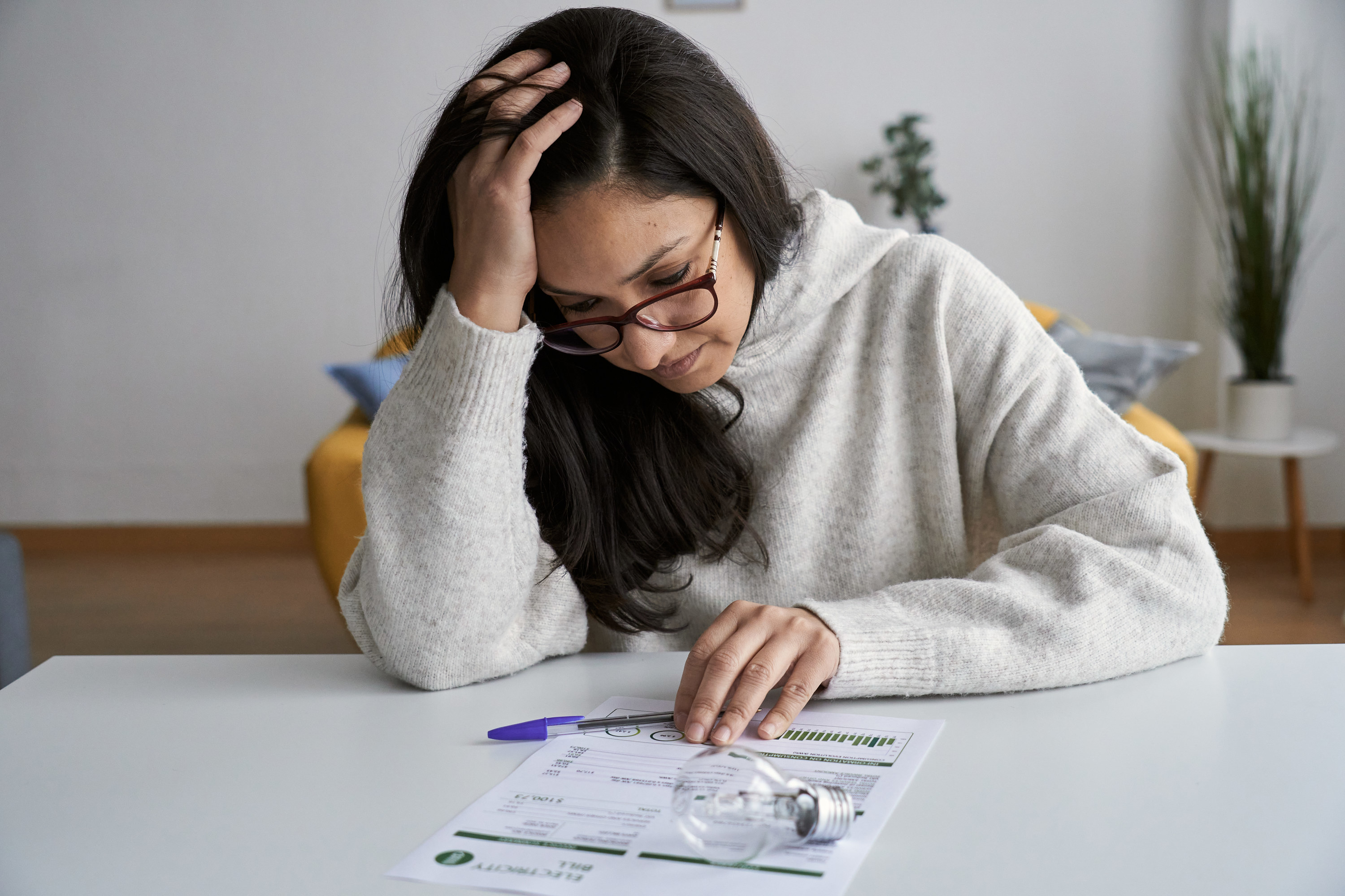a woman looking stressed down at her bills