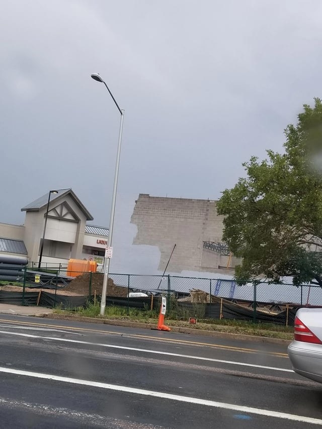 A building that looks like it&#x27;s being painted the same color as the sky