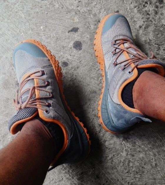 Reviewer wearing gray and orange hiking sneaker