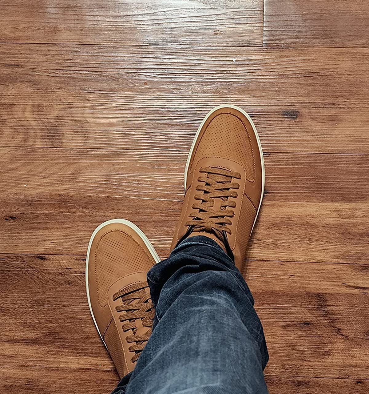 Reviewer wearing brown sneakers