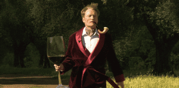 Conan O&#x27;Brien carrying a comically large glass of wine