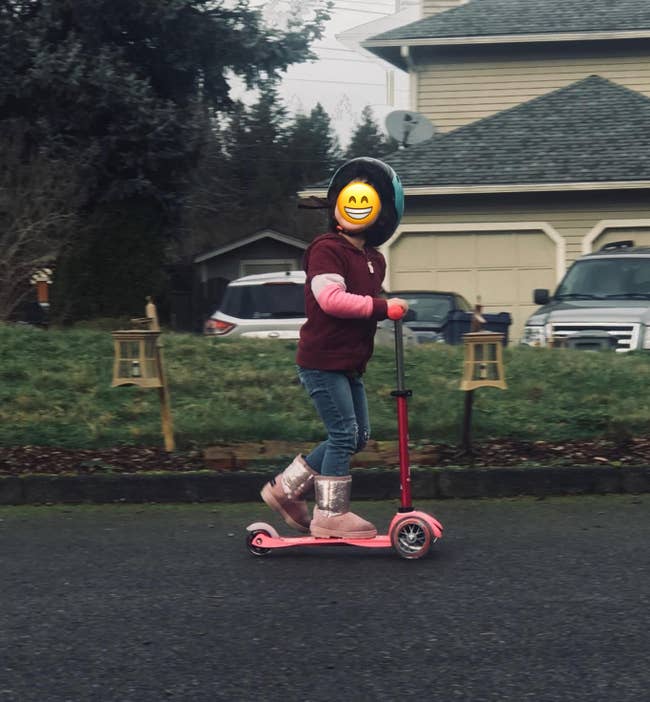 a reviewer's child on the pink scooter