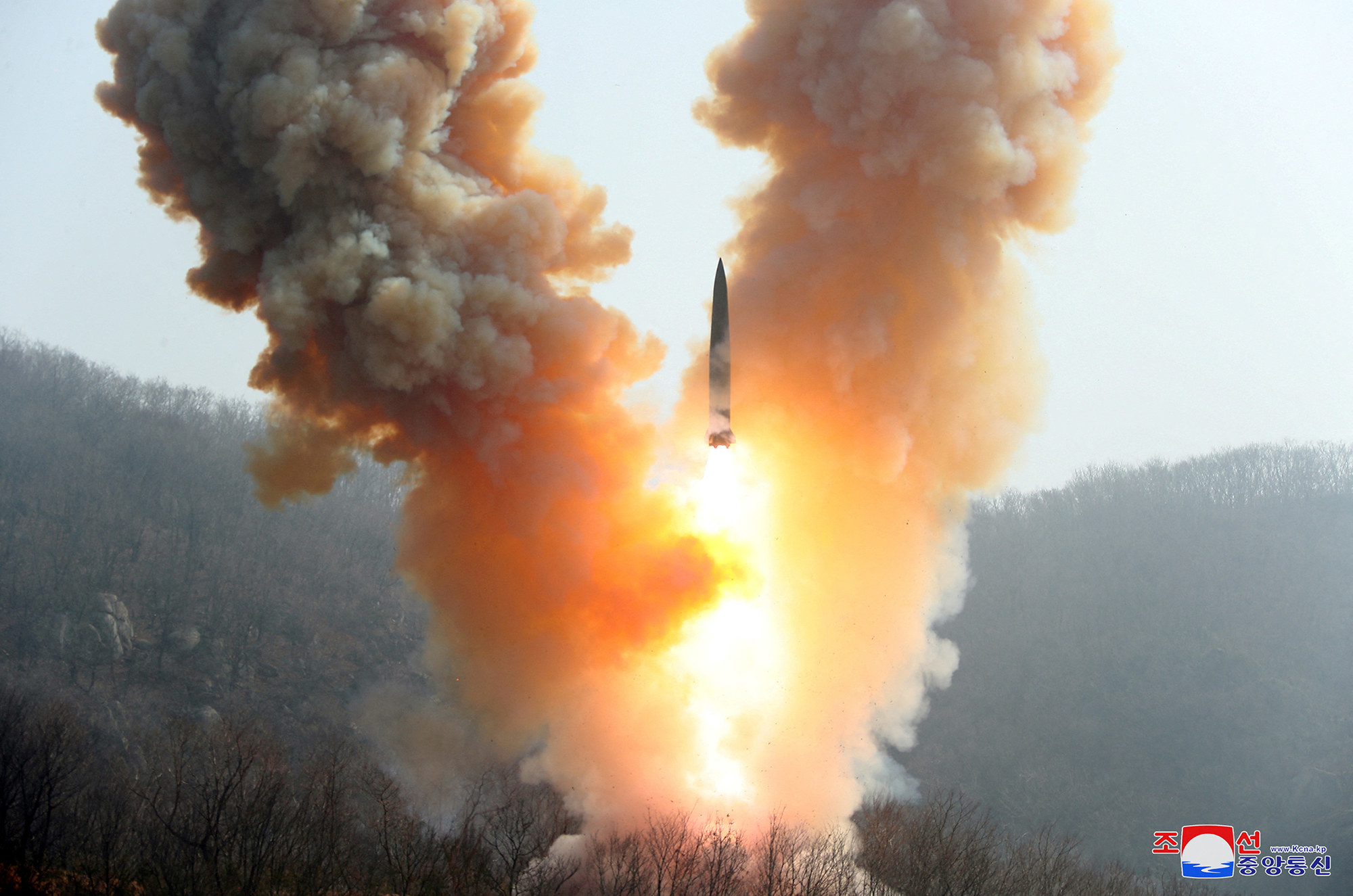 a missile surrounded by smoke and fire