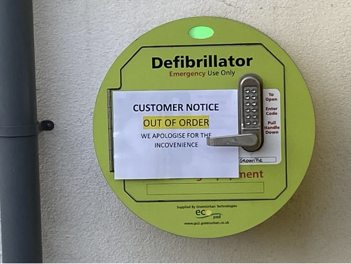 sign over a defibrillator that says &quot;out of order. we apologize for the inconvenience.&quot;