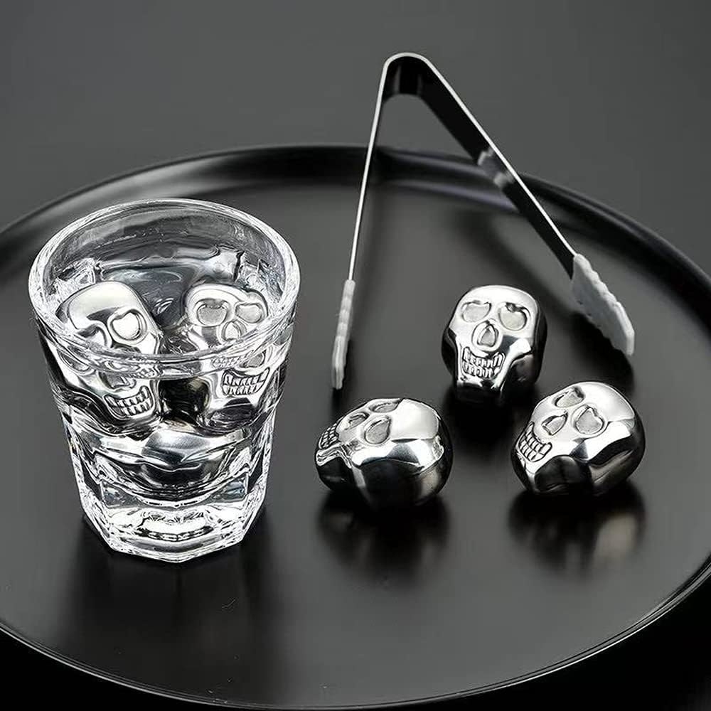 a set of steel skull-shaped drink stones in a glass