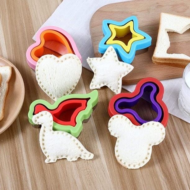 four of the different cutters in a heart shape, star shape, dinosaur shape, and mickey mouse shape