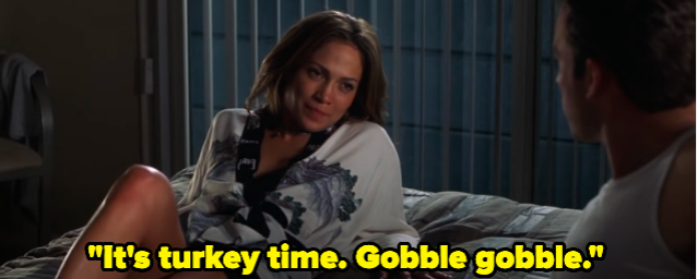 A woman lying on a bed saying, &quot;It&#x27;s turkey time. Gobble gobble.&quot;
