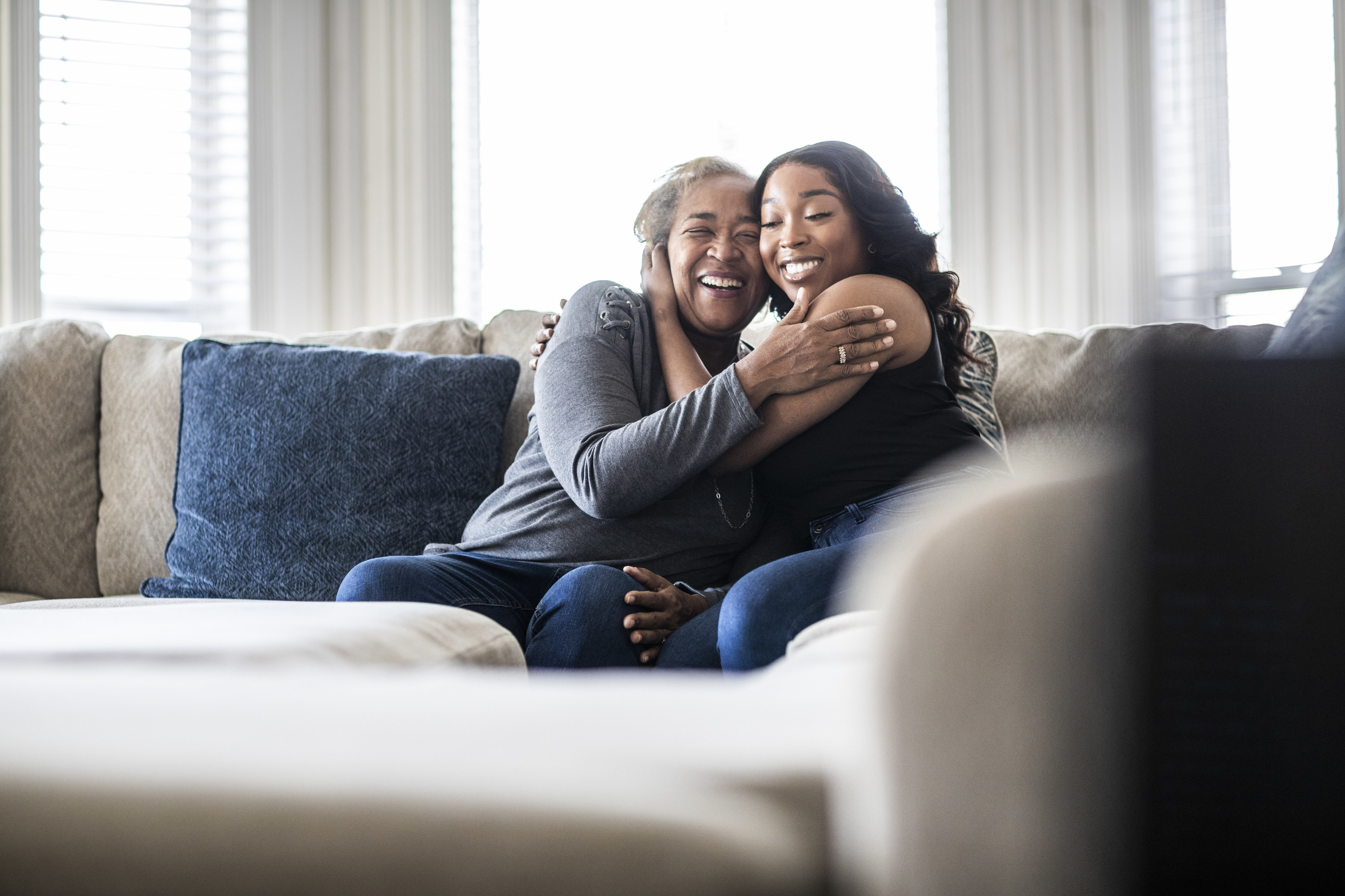 a mother and daughter hugging indoors