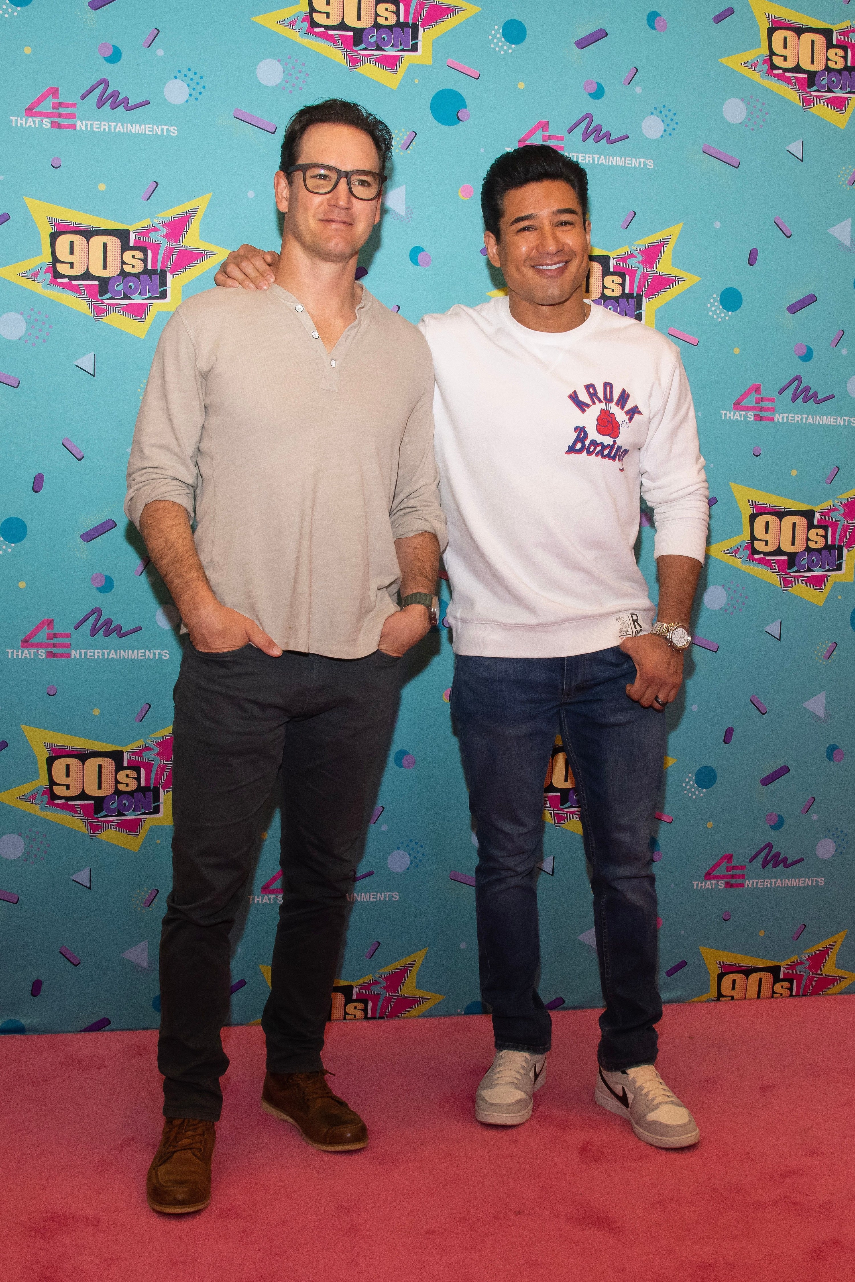 Mario Lopez with his arm around Mark-Paul Gosselar&#x27;s shoulders as they pose on the red carpet