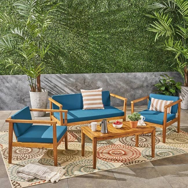 wood patio set with blue cushions