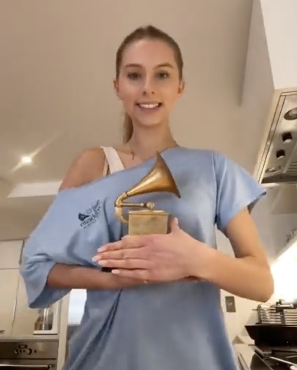 Romy holds up a Grammy