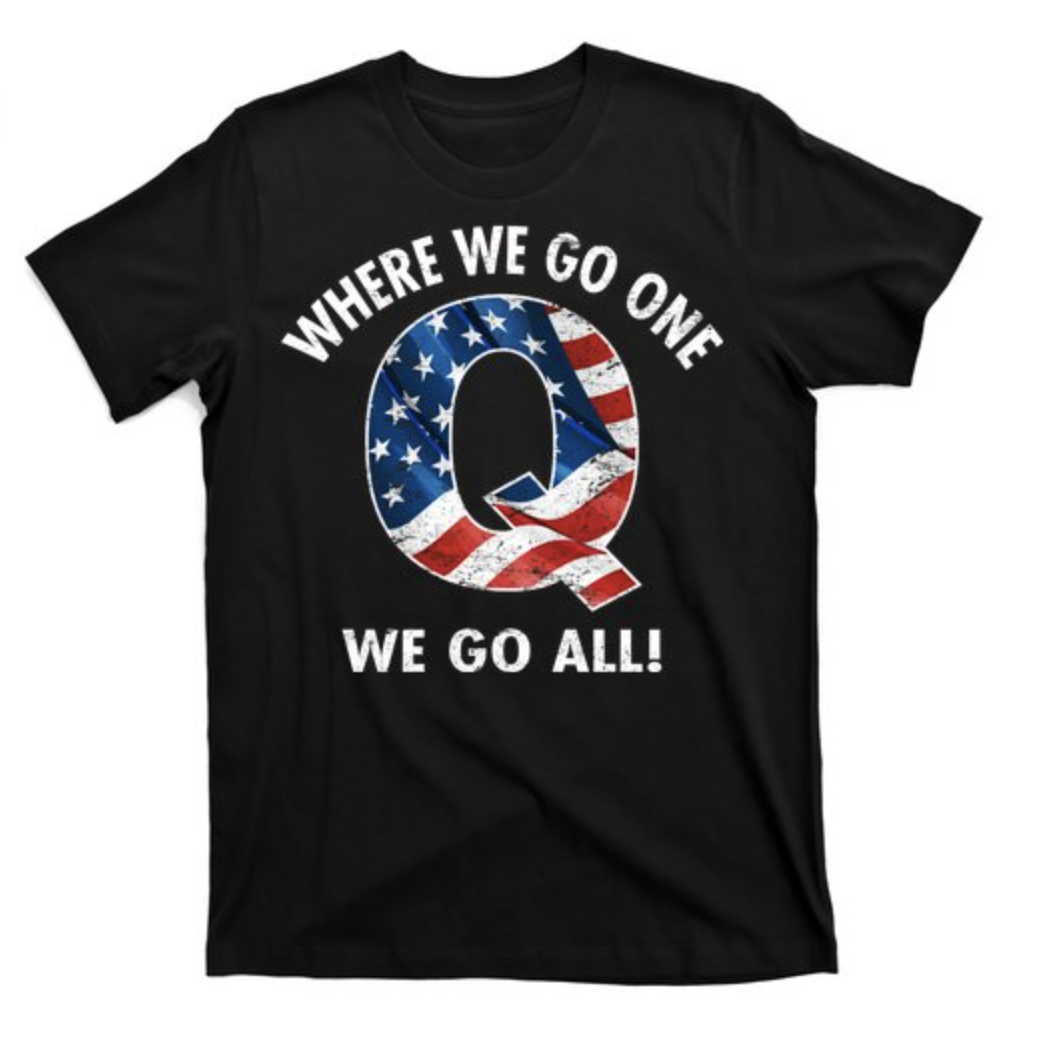 A black QAnon T-shirt has a large &quot;Q&quot; designed with the US flag&#x27;s stars and stripes, framed by the words &quot;where we go one, we go all&quot; above and below it