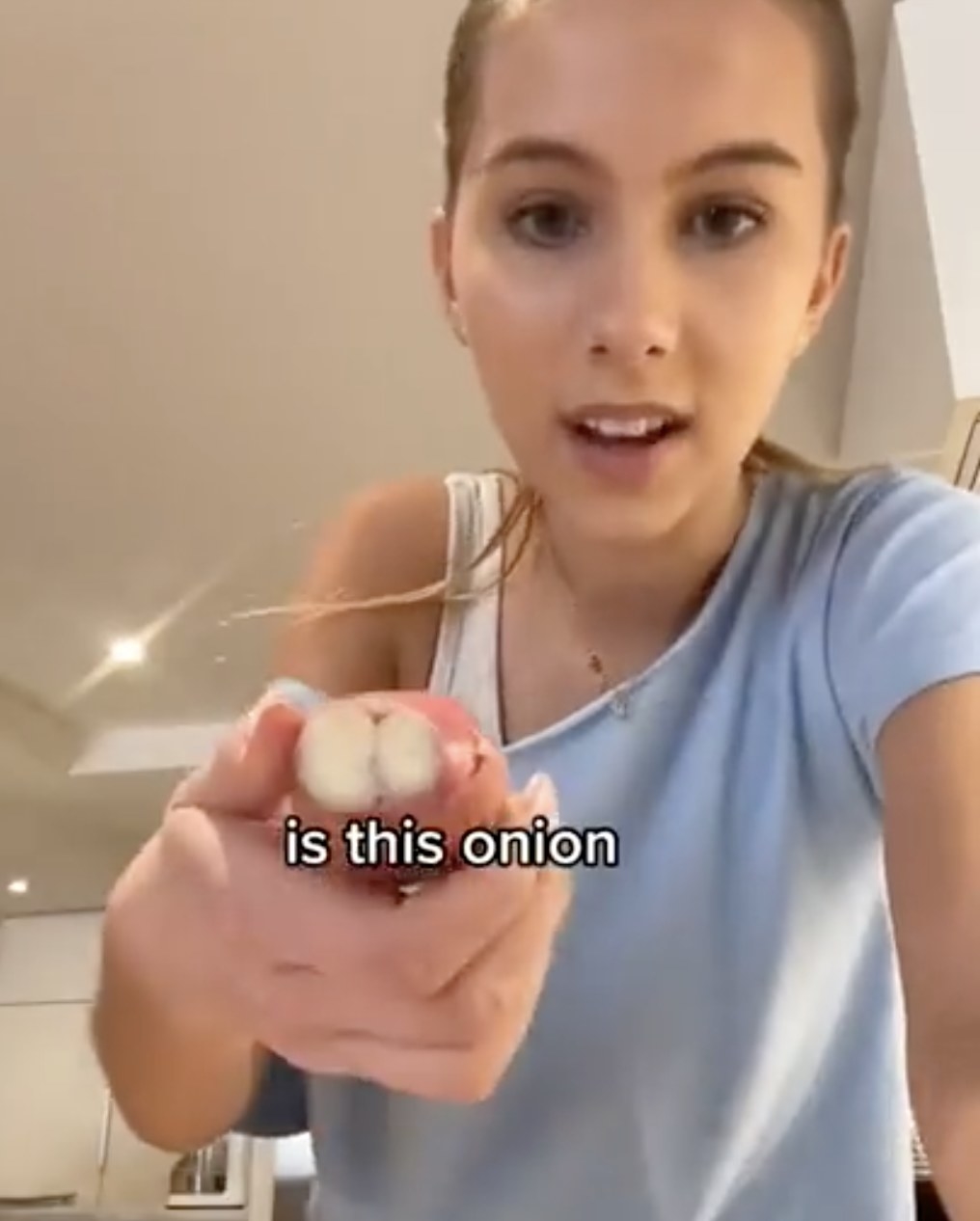 Romy holds up garlic while asking if it&#x27;s an onion