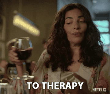 A woman making a toast &quot;To therapy&quot;