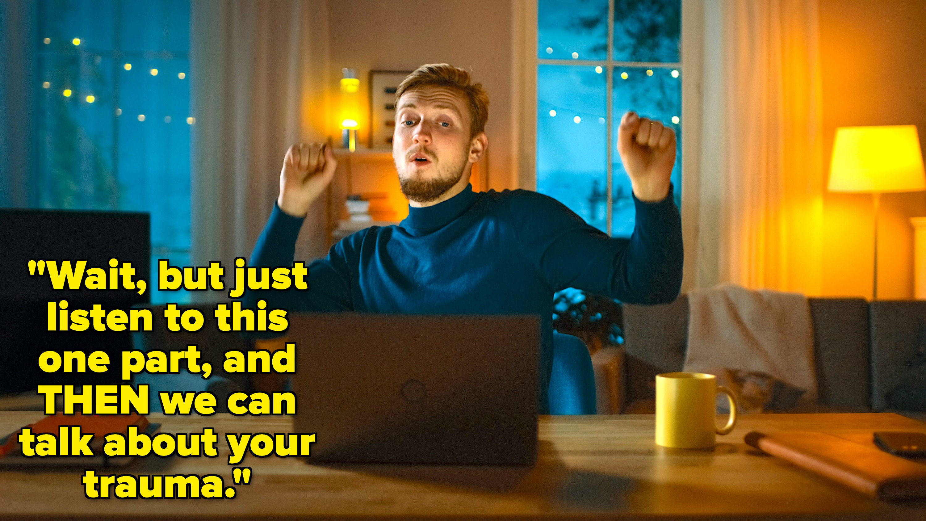 A man looking outraged at his computer with his hands up