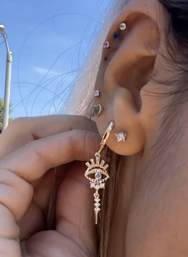 reviewer detail shot of the gold drop dangle earrings