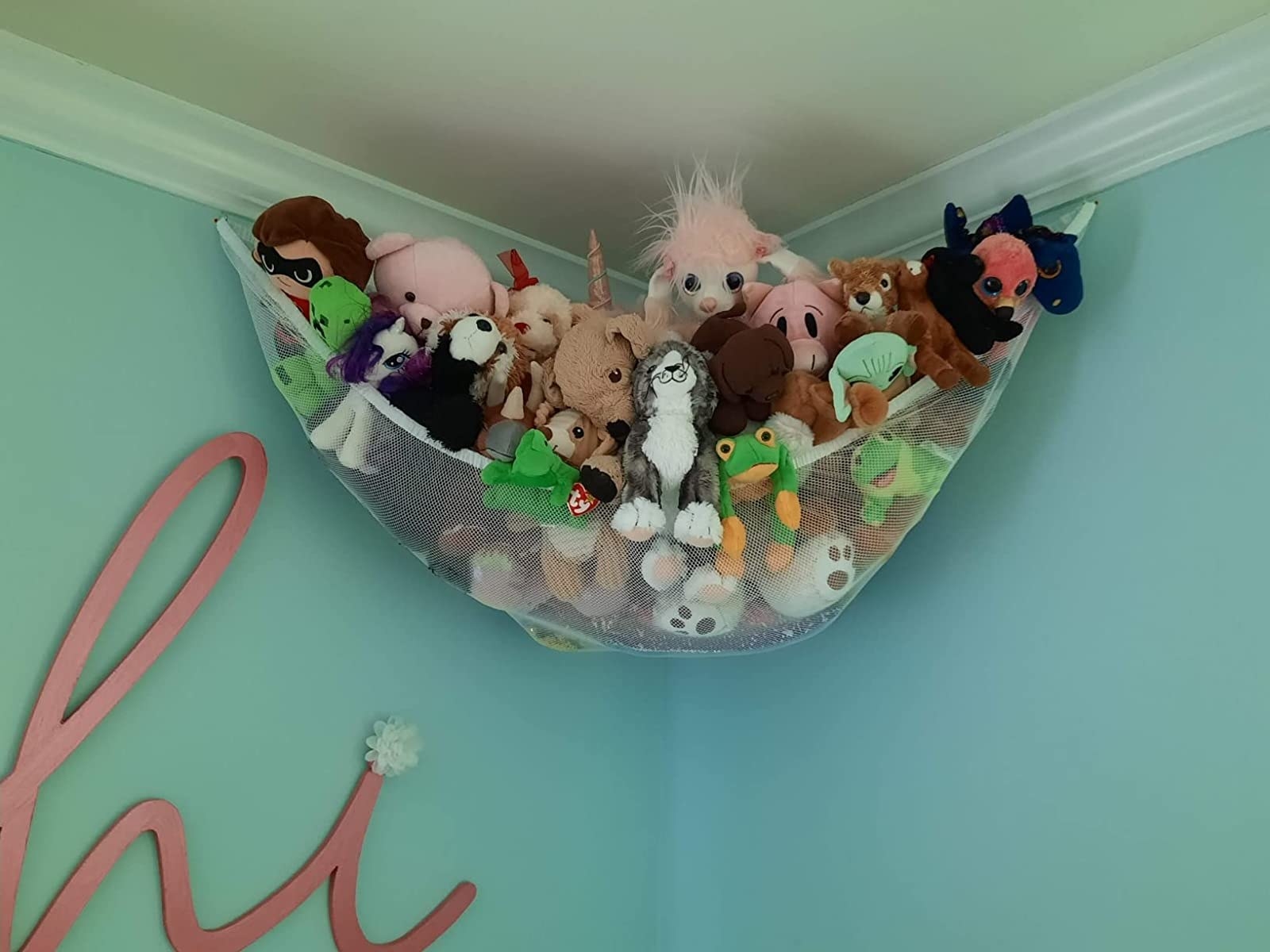 a reviewer photo of stuffed animals in the hammock