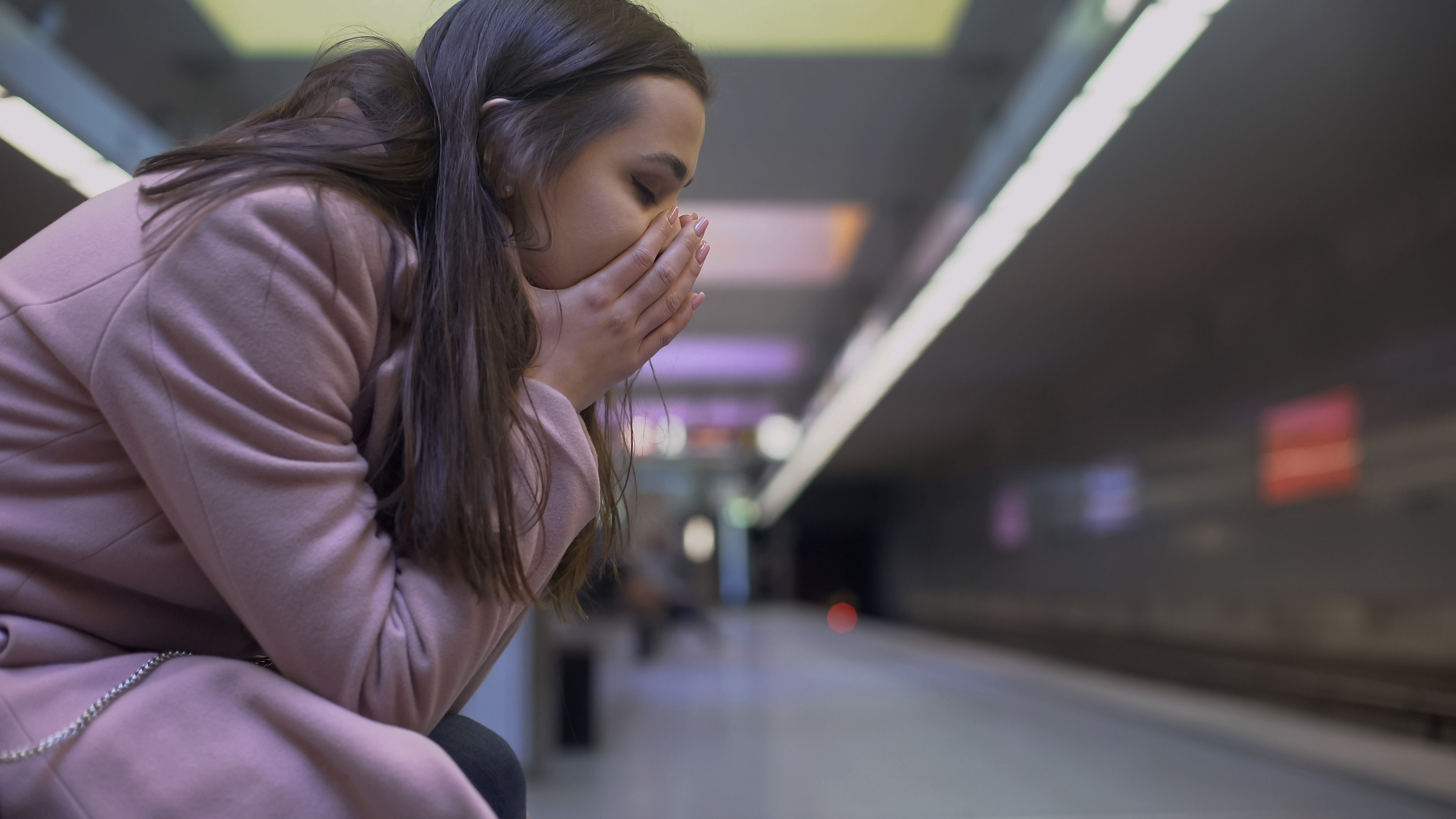 Woman having panic attack in subway station