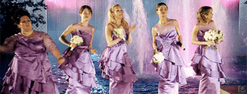 a gif of the cast of bridesmaids dancing