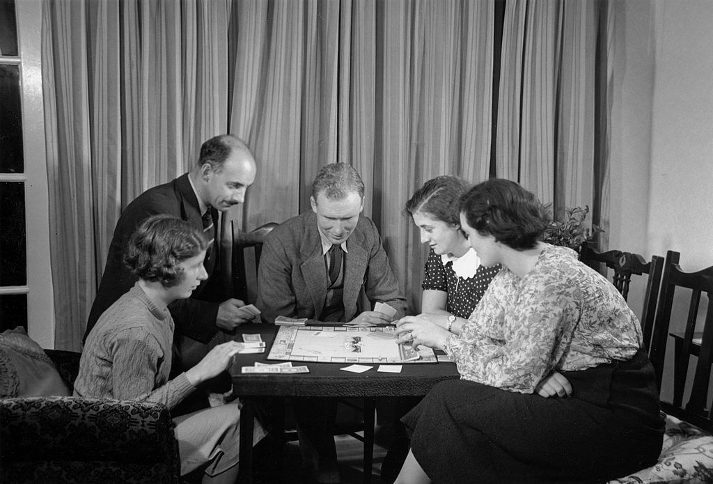 A family playing a game of Monopoly, c 1930