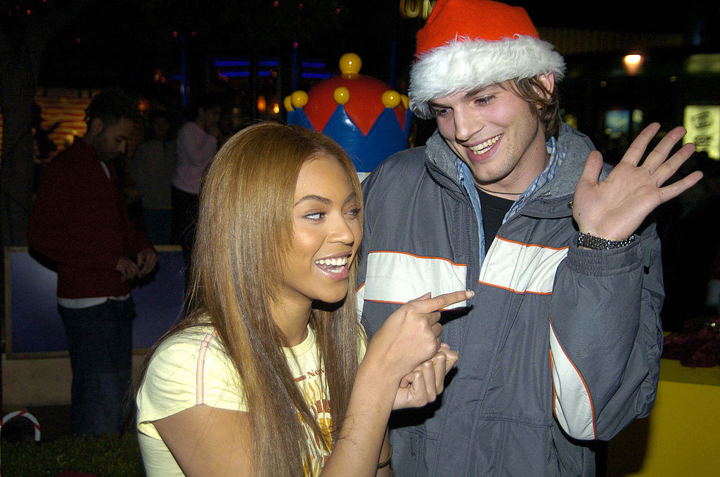 They&#x27;re both smiling, and he&#x27;s wearing a Santa hat