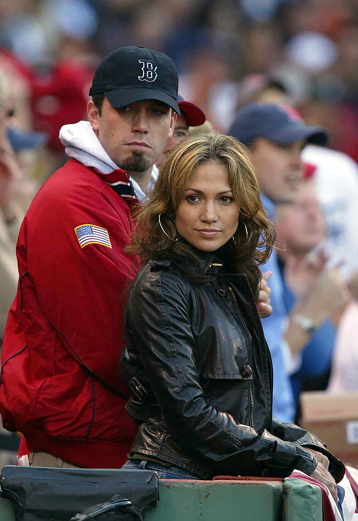 He&#x27;s wearing a Boston Red Sox cap and standing with JLo