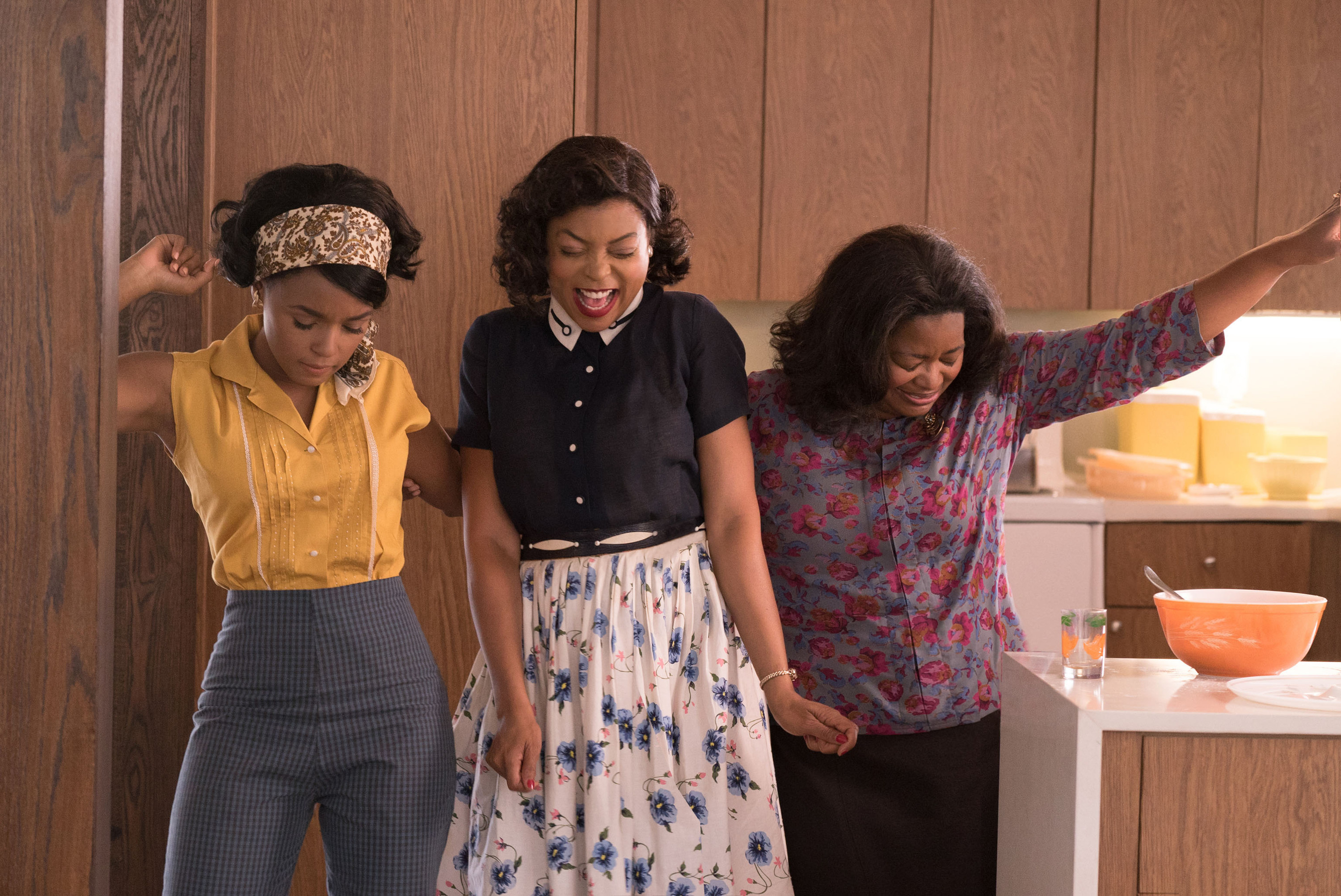 Three women celebrating in the kitchen