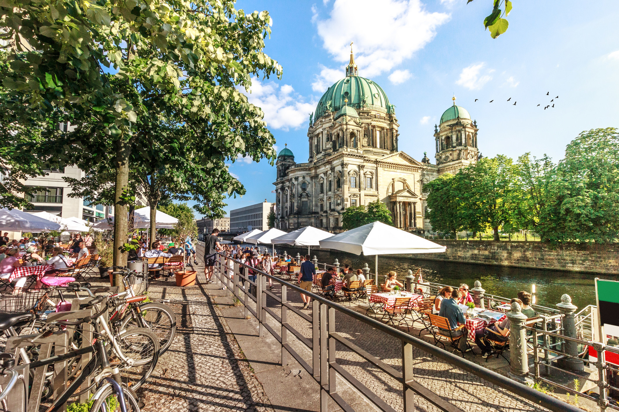 People relaxing along the river in Berlin.