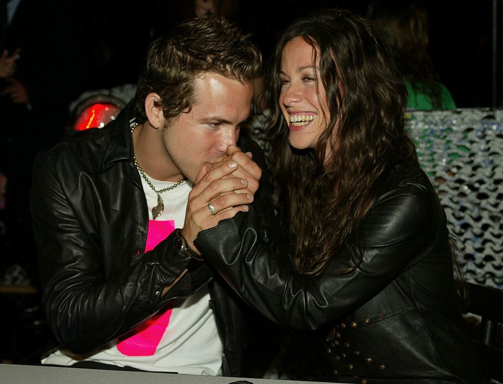 Another photo of him kissing her hand as she smiles
