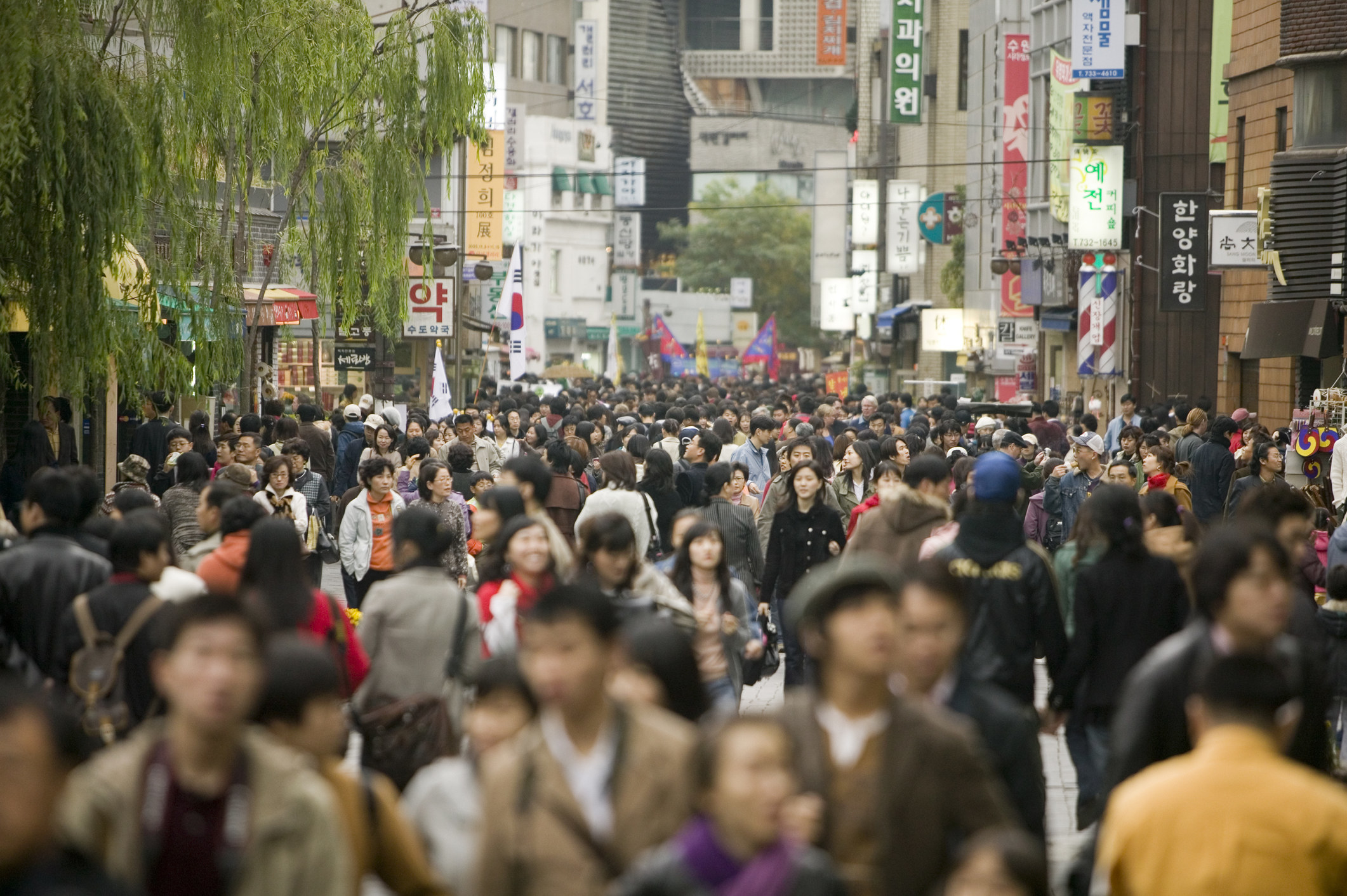 A busy street in South Korea filled with people.