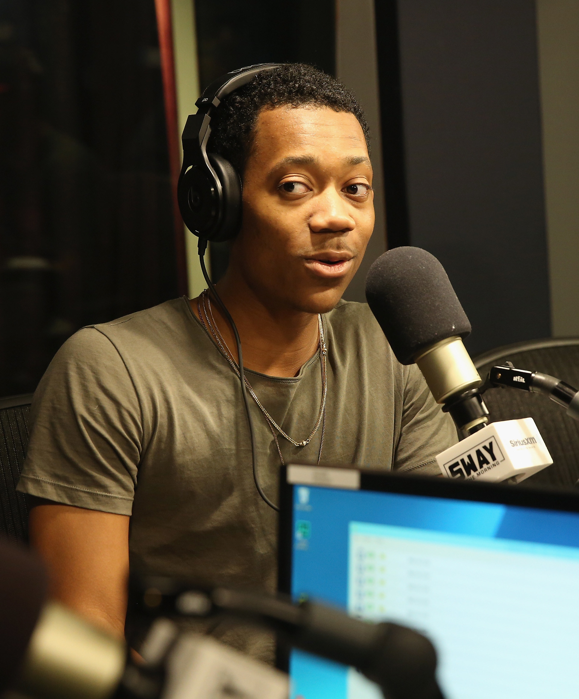 Tyler speaking into a mic during a radio interview