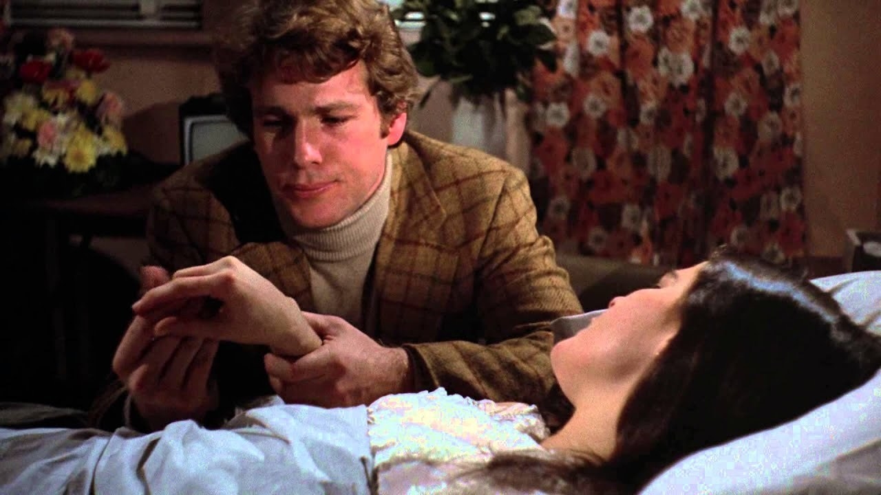 Oliver (Ryan O&#x27;Neal) holds Jenny&#x27;s (Ali MacGraw) hand as she dies in &#x27;Love Story&#x27;