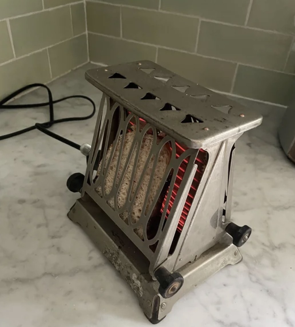 old toaster toasting a piece of bread