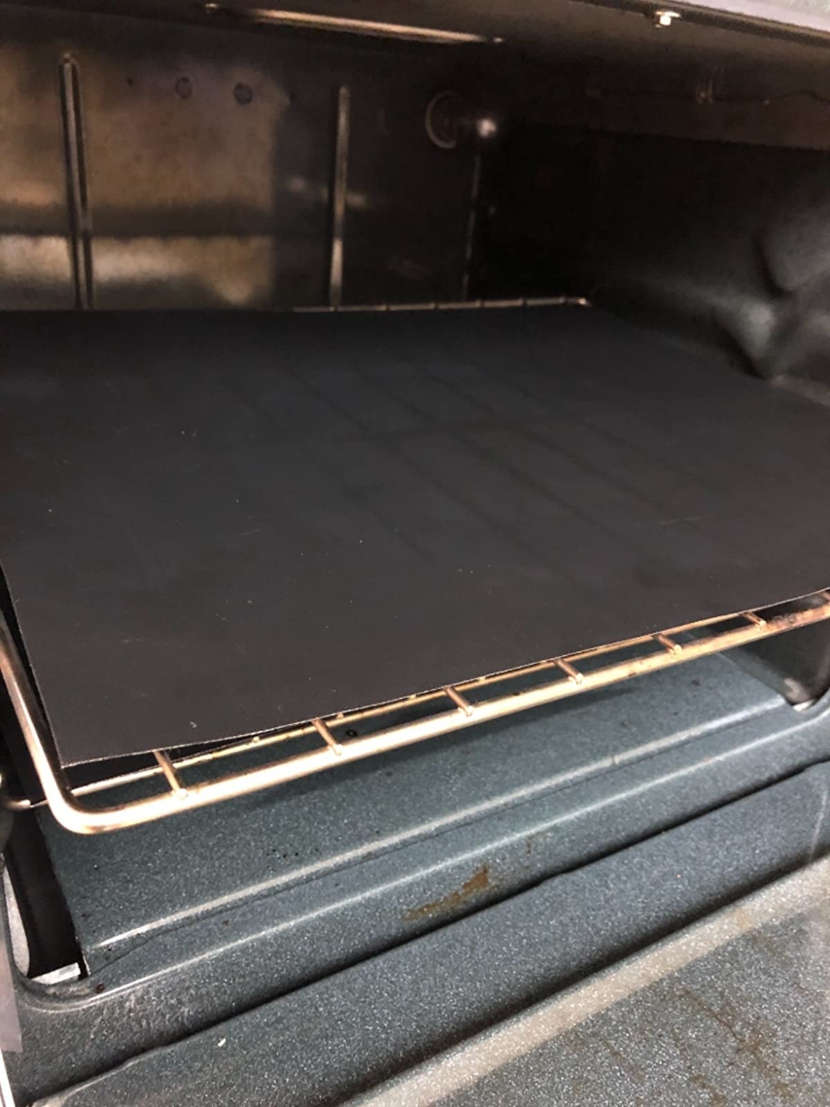 Reviewer image of black liner inside their oven