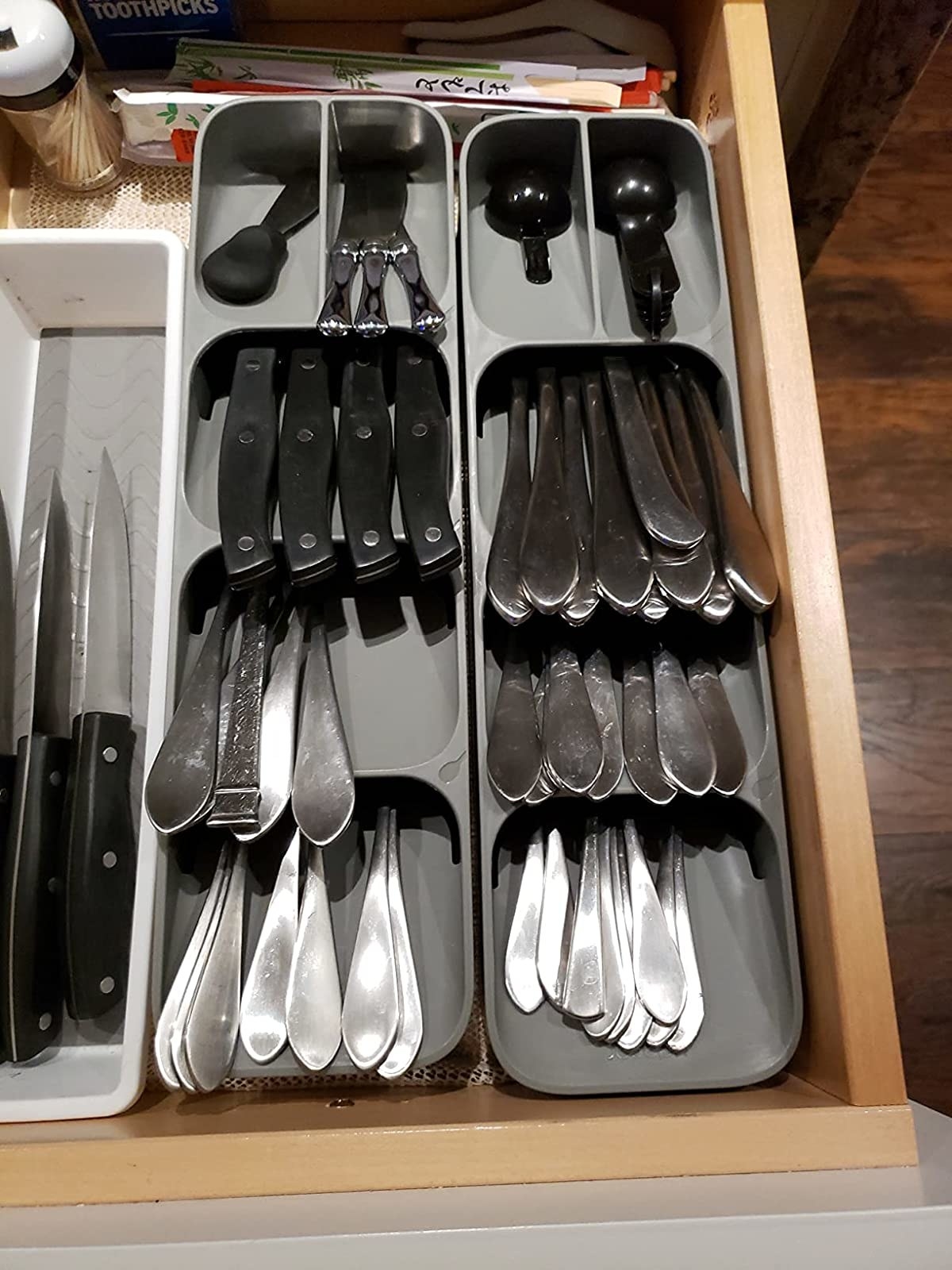 Reviewer image of flatware in two gray organizers inside their drawer