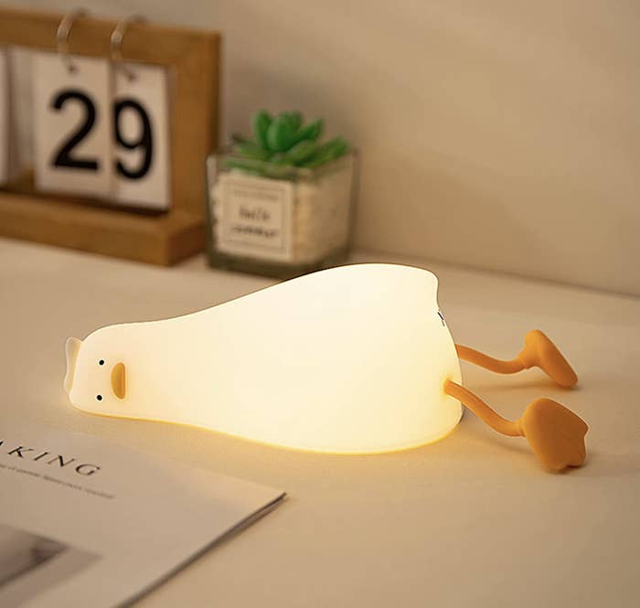 the duck lamp lit up on a desk