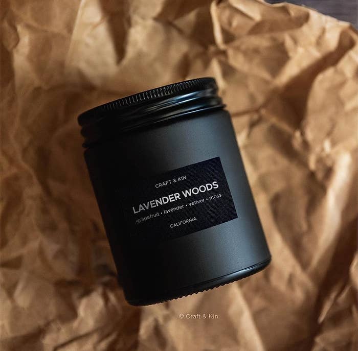 a luxe looking candle on a bed of crumpled paper