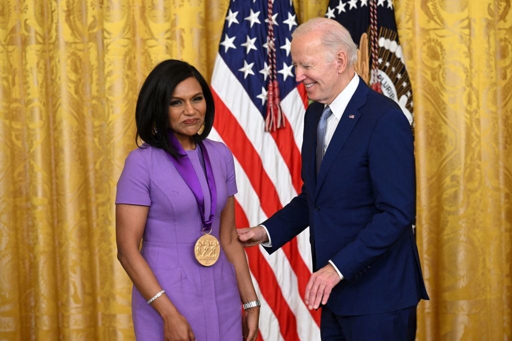 Mindy looking at the audience while wearing her medal that President Biden placed on her