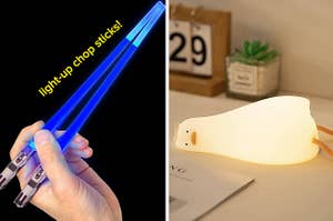 a person holding up light up chopsticks and a duck lamp on a desk