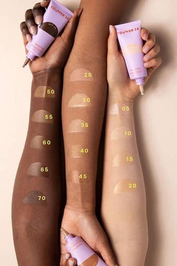 three models with swatch patches of each shade