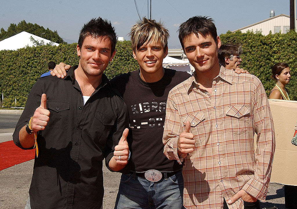 the three sporting short spiky hair, one with bangs and highlights