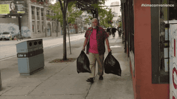 a gif of a character from kim&#x27;s convenience taking out the trash